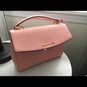 Michael Kors Pink handbag with strap.